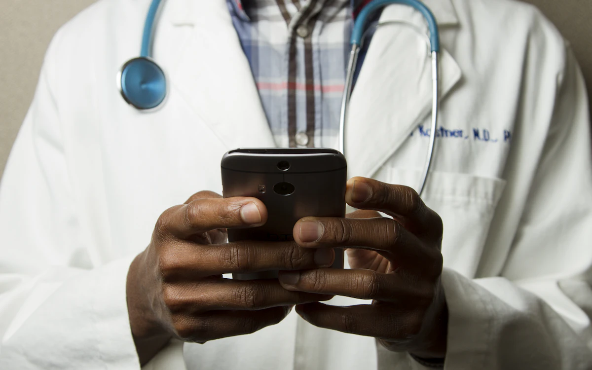 Healthcare professional using a mobile device in a clinical setting